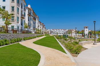Playground adjacent  to expansive green area